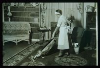 Woman vacuuming. Black and white photo.